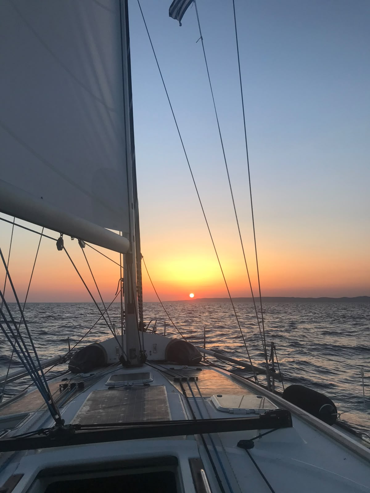 Relaxing on the foredeck under blue skies